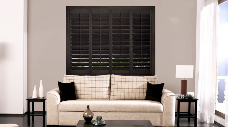 Dallas living room with stained wood shutters.